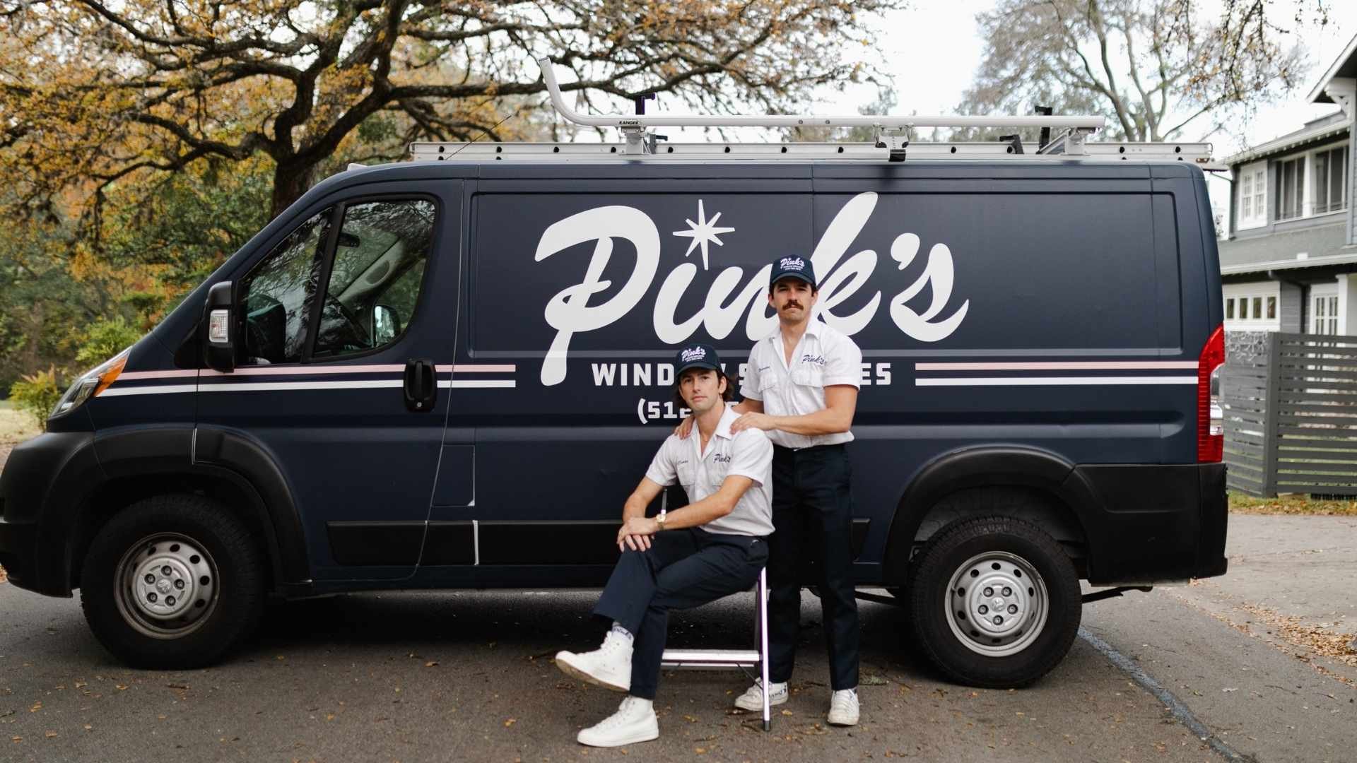 The owners of Pink&rsquo;s posing in front of their van.