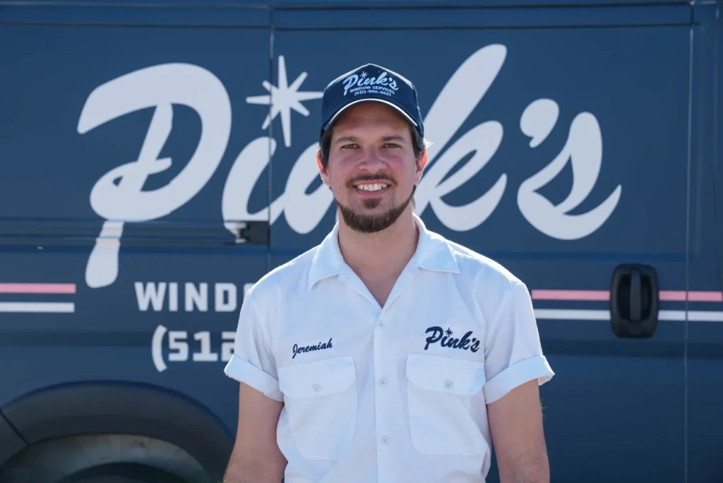 Man in uniform by Pink's Windows Round Rock van